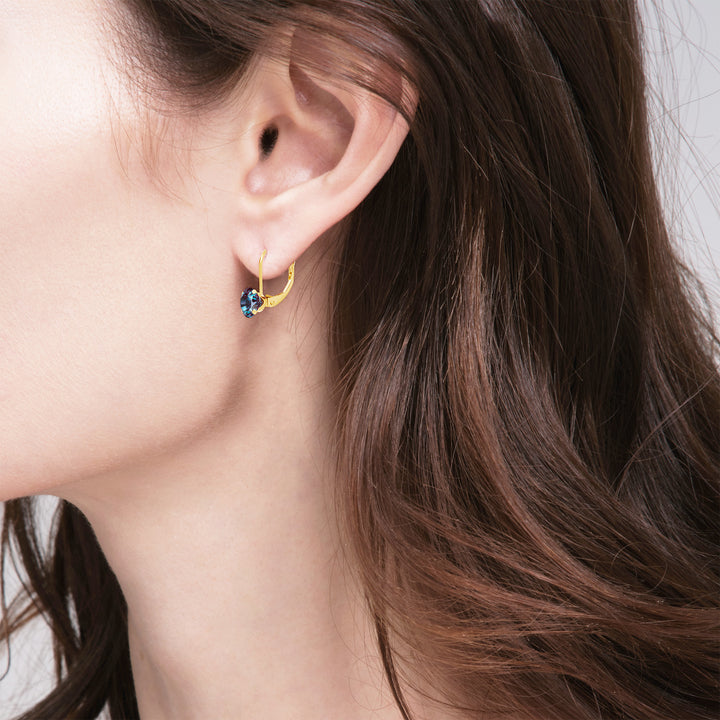 Model wearing a 14K yellow gold lab-grown alexandrite earring, side profile with hair down | Sada Jewels