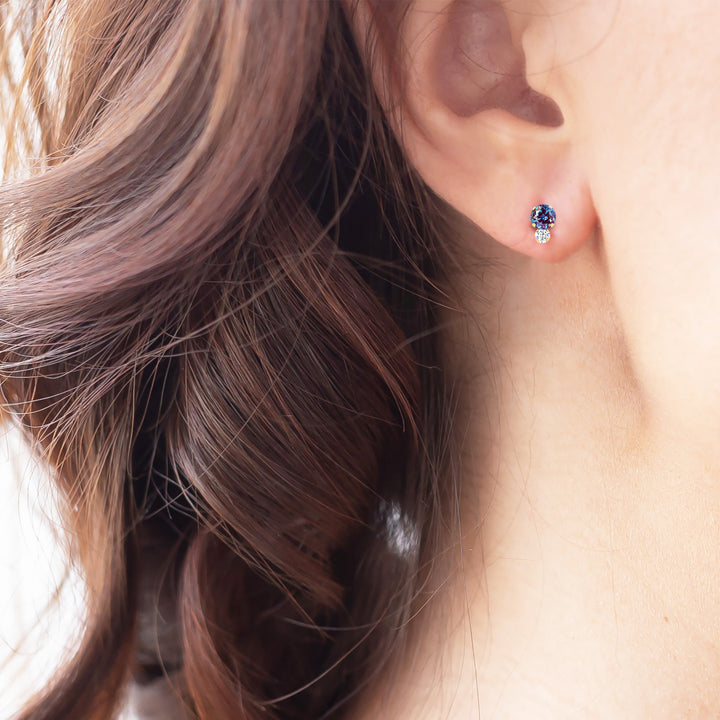 Lab-grown alexandrite stud earring on the ear, gemstone reads teal-blue | Sada Jewels