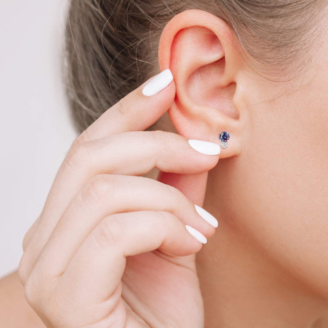 Fingers beside the alexandrite stud earring show its petite size | Sada Jewels